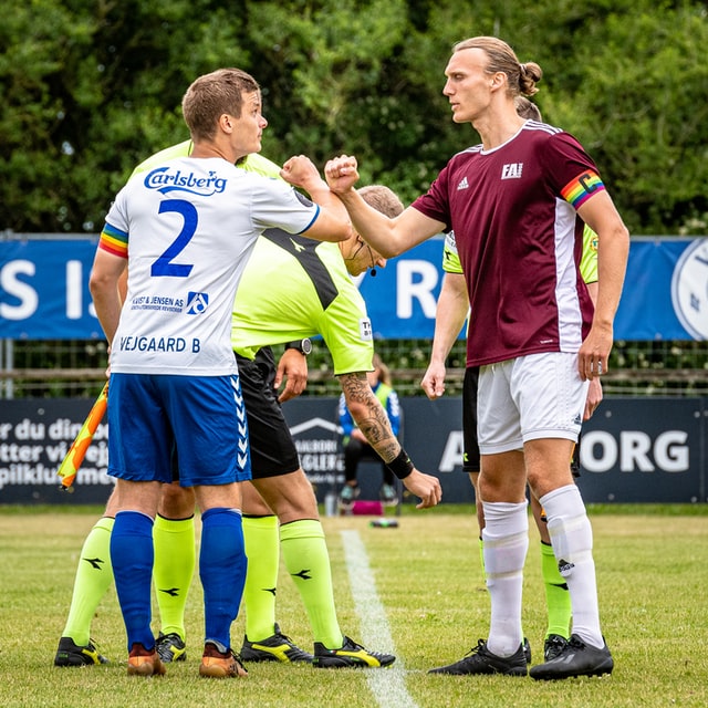 two men greeting each other at the start of a soccer match