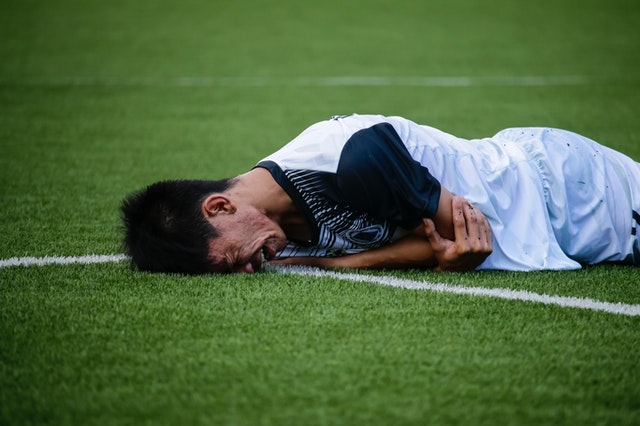 soccer player lying down injured