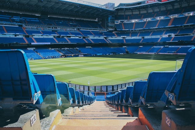 empty soccer stadium with blue seats