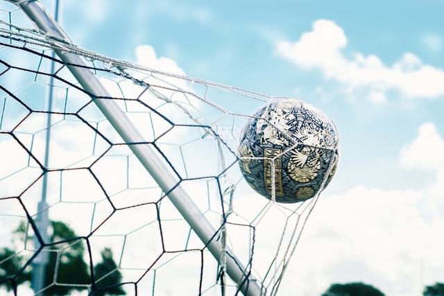 Soccer ball hitting the back of the net