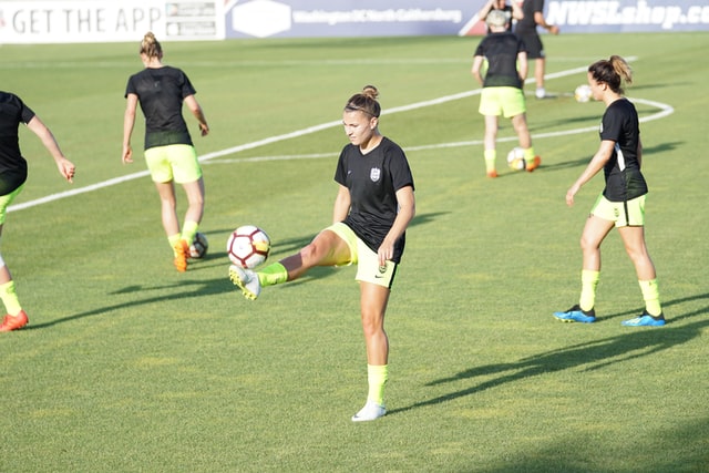 Female soccer players warming up